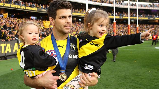 Cotchin carrying his daughters on a lap of honour after winning the 2017 AFL Grand Final. Picture: Getty Images