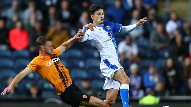 Callum Elder, playing for Hull City, makes a tackle against Blackburn Rovers.