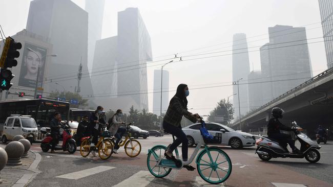 People crossing a road on a polluted day in Beijing. Picture: AFP