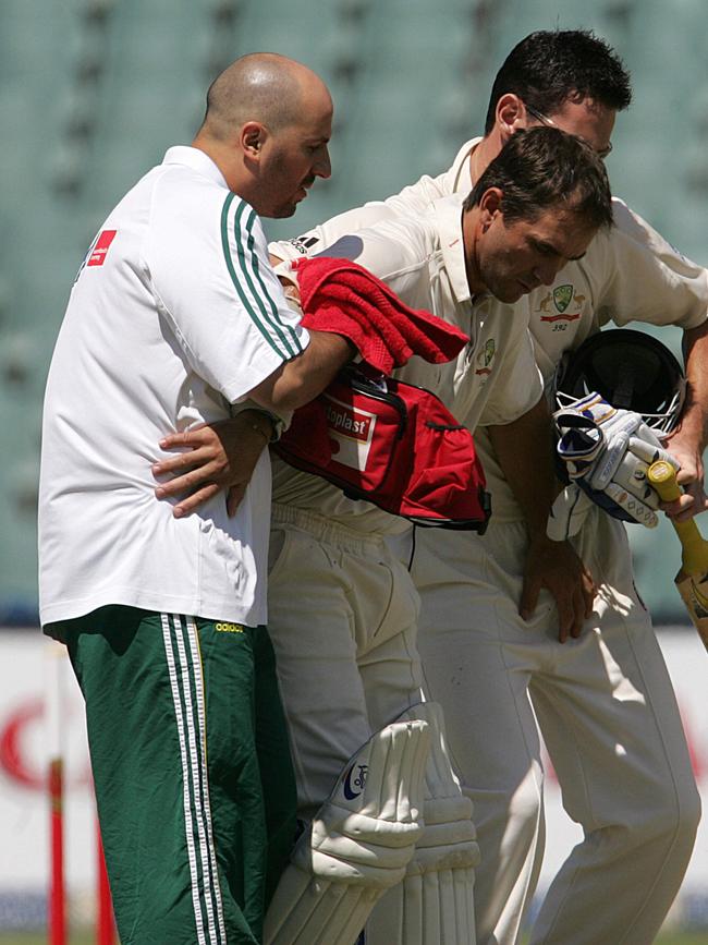 Medical staff help carry Justin Langer from the field after he was struck in the head by South African fast bowler Makhaya Ntini at The Wanderers in 2006. Picture: AFP