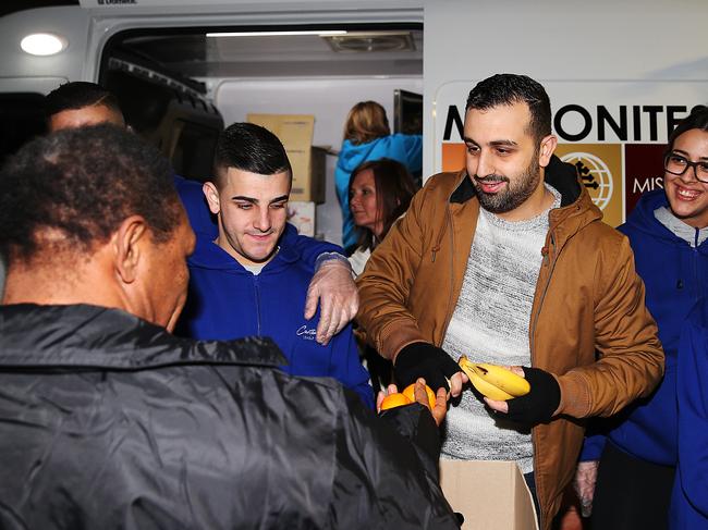 Charbel Azzi from Maronites on Mission is help by Canterbury League club staff to hand out food to the homeless in Woolloomooloo.