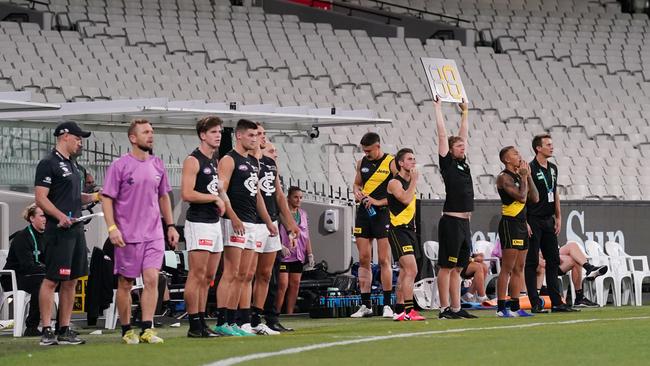 Richmond and Carlton players during Thursday night’s opening game of the AFL season, which was the first to be played with no fans present. Picture: AAP Image/Michael Dodge