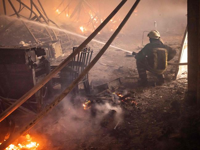 A firefighter fights a fire after Russian attacks struck a warehouse in the suburbs of Kyiv. Picture: AFP