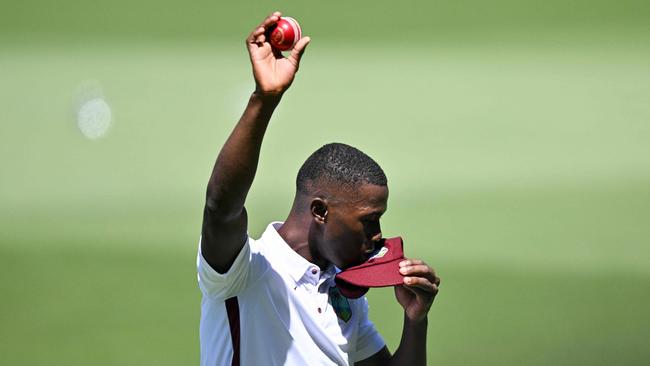 West Indies holds up the ball after taking five wickets on debut in Adelaide Picture: Izhar KHAN / AFP