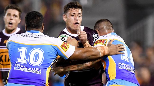 Teenager Jordan Riki gets tackled in Brisbane’s trial loss to the Gold Coast. Picture: Bradley Kanaris/Getty Images.