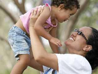 Kate Gumaka with her two-year-old daughter Keilani Lelo enjoy the Jacaranda Festival at Goodna on Saturday. . Picture: Sarah Harvey