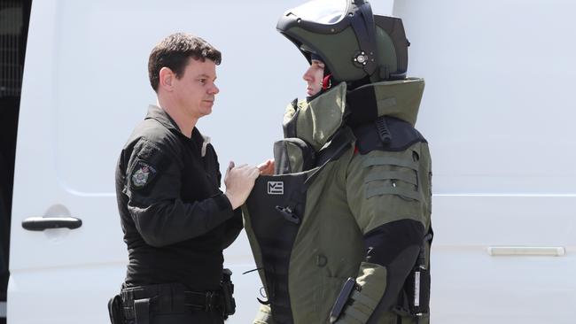 A bomb squad member suits up for safety checks. Picture: AAP Image/David Crosling