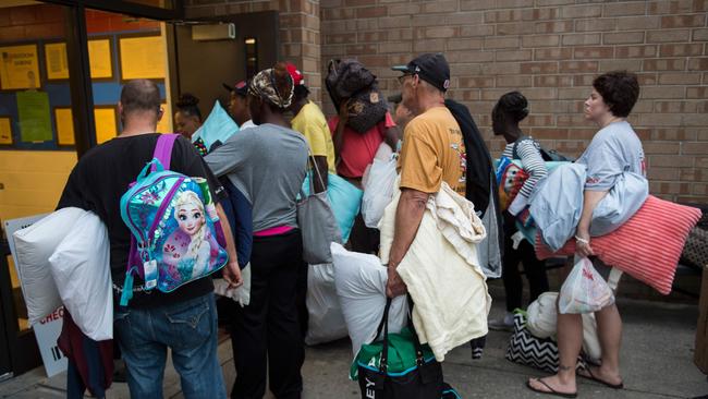 People line up to enter a hurricane shelter at Trask Middle School in Wilmington, North Carolina after warnings Hurricane Florence would deliver a “direct hit” to the US East Coast. Picture: Andrew Caballero-Reynolds/AFP