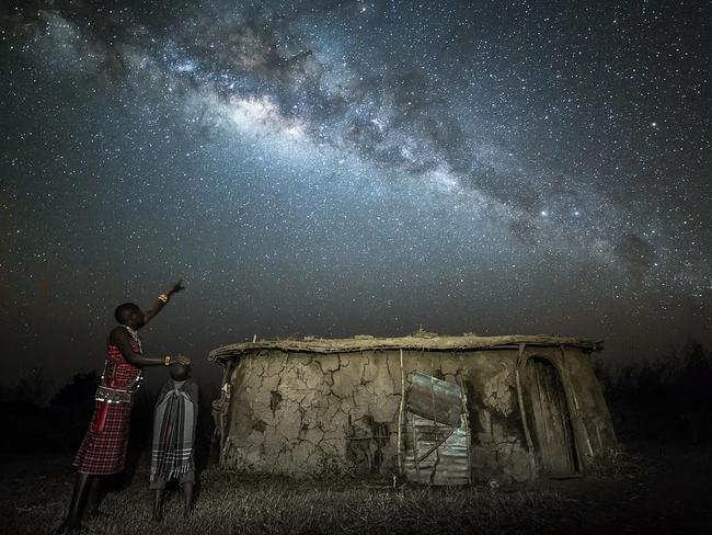 A Wise Son Makes a Glad Father ... The touching scene of a Maasai warrior bestowing his knowledge of the stars on his son as they gaze up at the Milky Way. The Maasai tribe use the stars to navigate across the east African plains in order to find new grazing grounds for their livestock. The photographer aimed to capture the moment that the knowledge was passed down from father to son and had planned the shot meticulously down to the perfect spot, even though it required him to lie down in dried cow excrement. Picture: Robin Stuart, Insight Astronomy Photographer of the Year 2016 People and Space Highly Commended