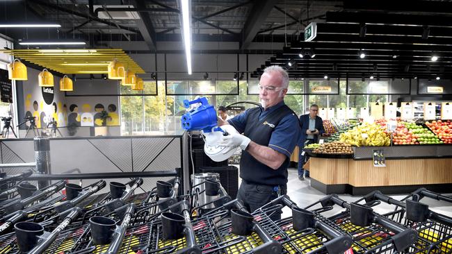 Mark Nugent sprays disinfectant across the Drakes supermarket at Goodwood.