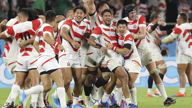 Japanese players celebrate their win over Ireland on Saturday. Picture: AP