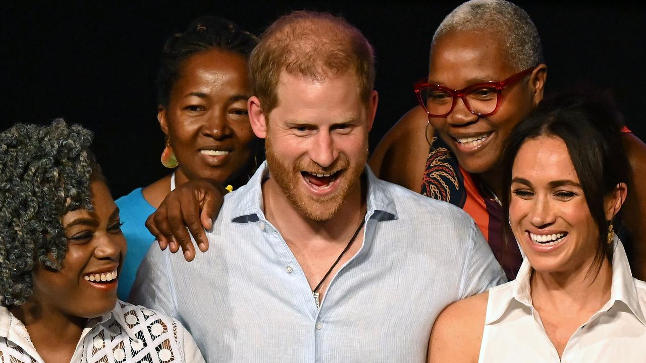 Prince Harry and Meghan Markle pose for a picture with Colombia's former Education Minister Aurora Vergara (L) and other participants, at the end of the 