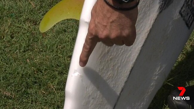 Large shark teeth marks can be seen on Lee Jonsson's surfboard. Mr Jonsson was attacked at Ballina. Source: 7 News.