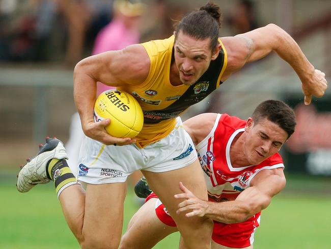 Waratah co-captain Brodie Carroll - attempting a tackle on Nightcliff’s Cameron Ilett - is now fully fit after picking up a freak elbow injury last season. Picture: GLENN CAMPBELL