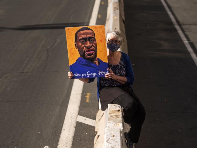 A woman holds up a portrait of George Floyd outside court. Picture: Getty Images/AFP