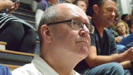 Queensland basketball identity Allan Woodford, who passed away on Saturday, where he loved to be – on the sidelines at a basketball game. Picture: Fan Fair