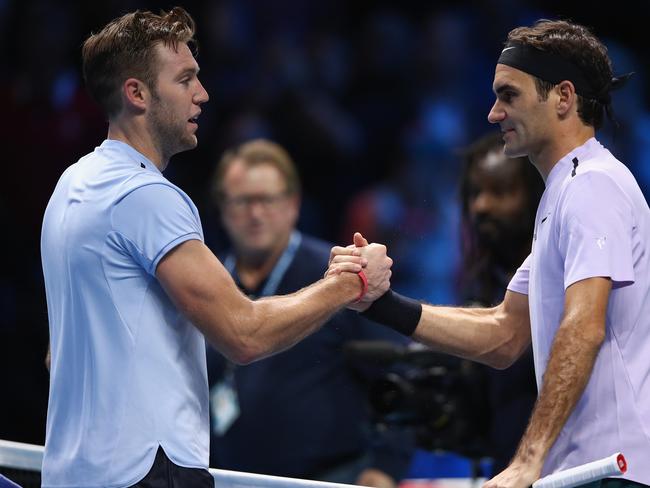 Roger Federer shakes hands at the net after his straight sets victory against Jack Sock.