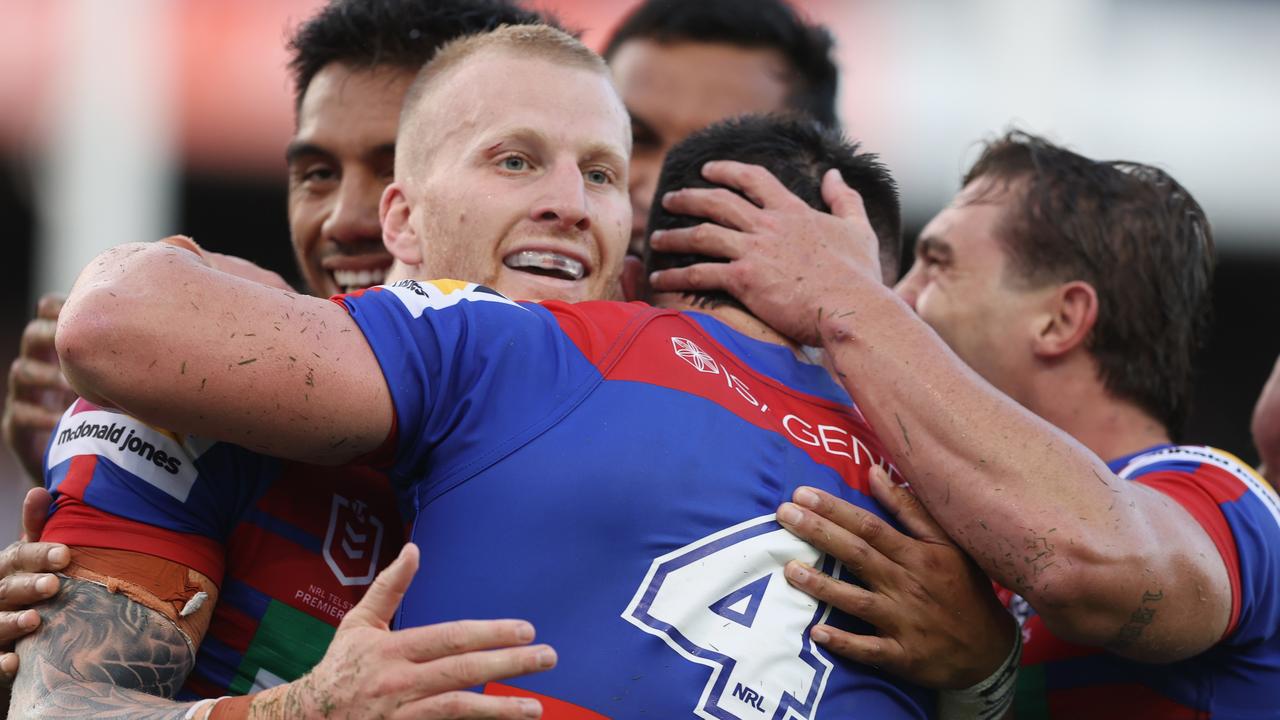 Mitch Barnett of the Knights celebrates his try with teammates.