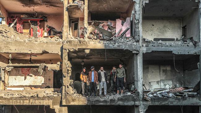 Palestinians check a half destroyed building following Israeli bombardment on Rafah, in the southern Gaza Strip. Picture: AFP