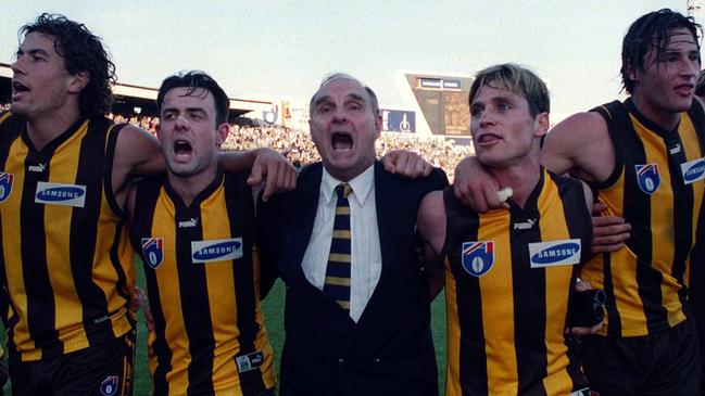 Hawthorn president Ian Dicker sings the club song with players Nathan Thompson, Daniel Harford, Shane Crawford and Jonathan Hay.