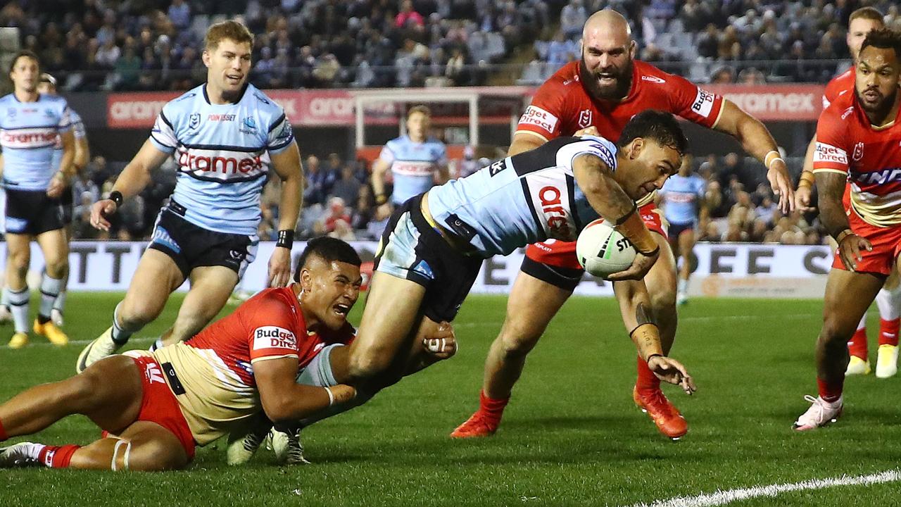 Briton Nikora of the Sharks scores a try over the top of Isaiya Katoa. Photo: NRL Photos / Brett Costello