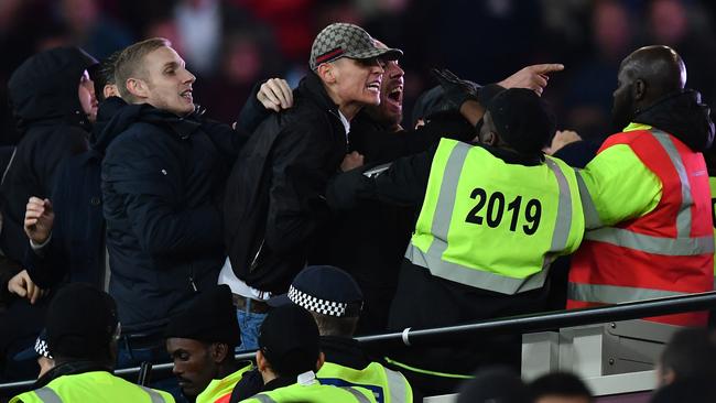 Fans clash with stewards during the EFL Cup fourth round match between West Ham United and Chelsea.