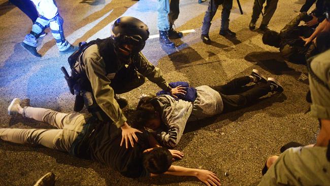 Police detain student protesters after they attempt to escape from Hong Kong Polytechnic University campus in November 2019. Picture: AFP