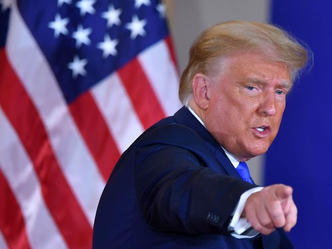 TOPSHOT - US President Donald Trump gestures after speaking during election night in the East Room of the White House in Washington, DC, early on November 4, 2020. (Photo by MANDEL NGAN / AFP)