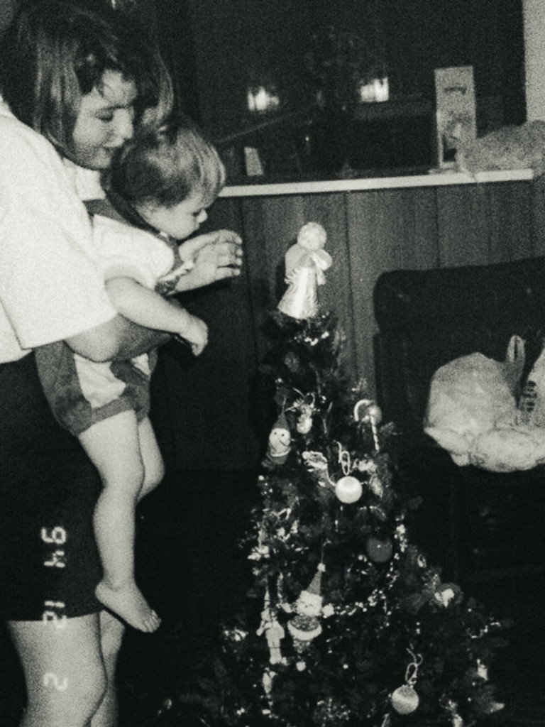 Ms Whitehead and daughter Amelia putting the angel on top of the tree in 1994. Picture: Supplied