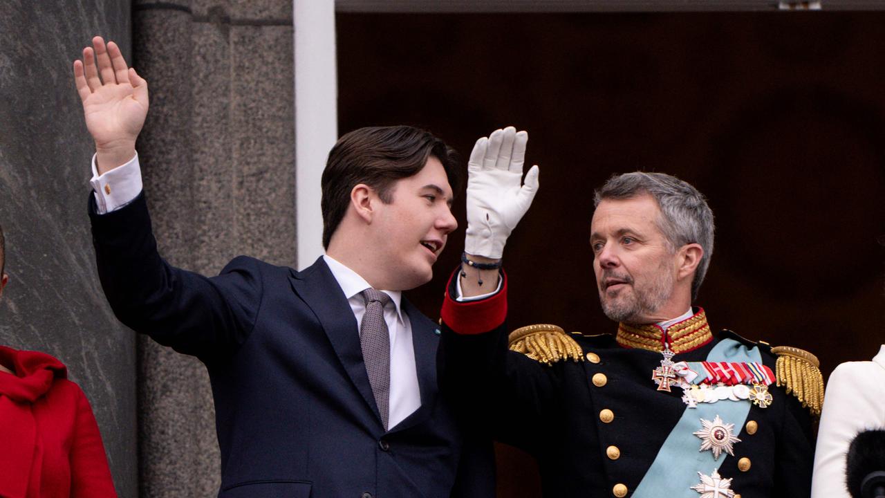 King Frederik X of Denmark and Crown Prince Christian (L) wave on the balcony of Christiansborg Palace in Copenhagen, Denmark on January 14, 2024, after a declaration on the accession to the throne by the Danish prime minister. Denmark turned a page in its history on January 14 as Queen Margrethe II abdicated the throne and her son became King Frederik X, with more than 100,000 Danes turning out for the unprecedented event. (Photo by Bo Amstrup / Ritzau Scanpix / AFP) / Denmark OUT