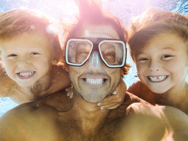SHFG. Dad and sons having fun doing a selfie underwater. Picture: iStock