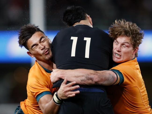 Jordan Petaia and Michael Hooper of the Wallabies make a tackle on Rieko Ioane of the All Blacks during the Rugby Championship and Bledisloe Cup match between the New Zealand All Blacks and the Australia Wallabies at Eden Park on August 07, 2021 in Auckland, New Zealand. (Photo by Anthony Au-Yeung/Getty Images)