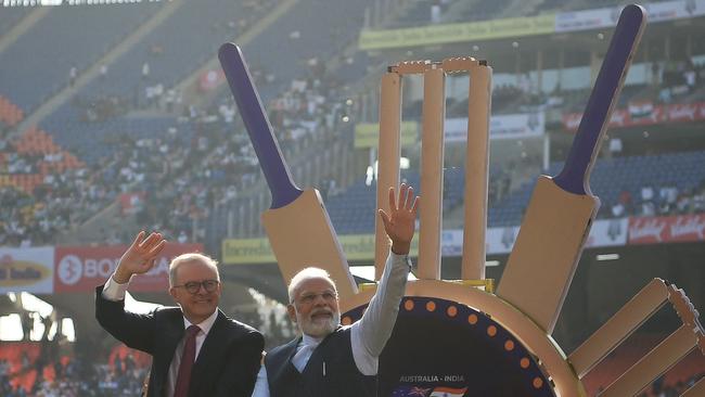 Indian Prime Minister Narendra Modi (R) and Australia's Prime Minister Anthony Albanese (L) wave to spectators at the Narendra Modi stadium in Ahmedabad, before the start of the fourth and final Test match. (Photo by Punit PARANJPE / AFP)