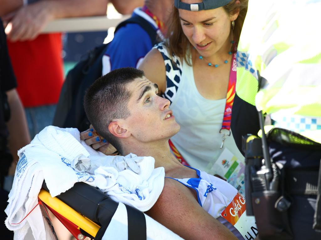 Callum Hawkins of Scotland is given medical assistance after the marathon.