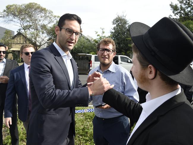 Josh Burns MP meets people gathered outside the Adass Israel synagogue. Picture: Andrew Henshaw