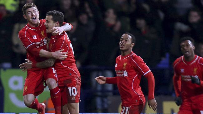 Liverpool's Philippe Coutinho, centre, celebrates with team-mates Alberto Moreno, left, and Raheem Sterling after scoring his side's second goal during their FA Cup Fourth Round Replay match at the Macron Stadium in Bolton, England, Wednesday Feb. 4, 2015. (AP Photo / Peter Byrne, PA) UNITED KINGDOM OUT - NO SALES - NO ARCHIVES