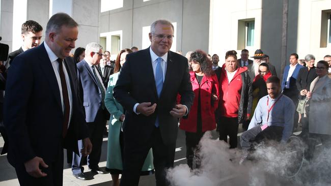 Anthony Albanese and Scott Morrison take part in the Welcome to Country smoking ceremony to mark the start of the 46th parliament. Picture: Kym Smith