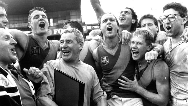 Williamstown players celebrate the 1990 VFA flag after Billy Swan’s winning kick.