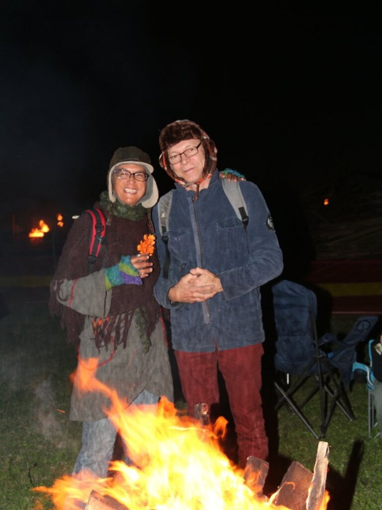 Cathy Godwin and Geoff Heller warm up behind one of the Fire Drums at the Killarney Bonfire and Fire Drum Night on Saturday, July 24, 2016.