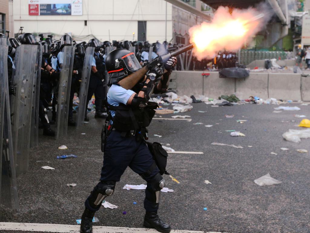 Police officer fires tear gas at protesters. Picture: Athit Perawongmetha/Reuters