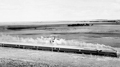 The Spirit of Progress races a biplane on its inaugural run from Melbourne to Geelong.