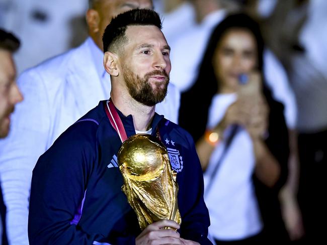 BUENOS AIRES, ARGENTINA - DECEMBER 20:  Lionel Messi holds the FIFA World Cup during the arrival of the Argentina men's national football team after winning the FIFA World Cup Qatar 2022 on December 20, 2022 in Buenos Aires, Argentina. (Photo by Marcelo Endelli/Getty Images)