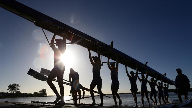 Nudgee College’s First VIII rowing team takes its boat from Pine River in 2017. Picture: Darren England.