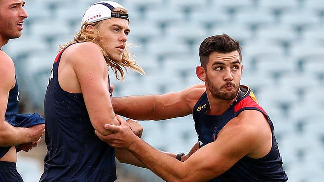 AFL - Crows players return to training at AAMI Stadium. Taylor Walker shows who's boss on the first day back to Hugh Greenwood - with Brodie Smith and Daniel Talia. Photo Sarah Reed.