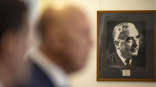 A portrait of Sir Robert Menzies hangs on the wall close to where the Leader of the Opposition, Peter Dutton stands.