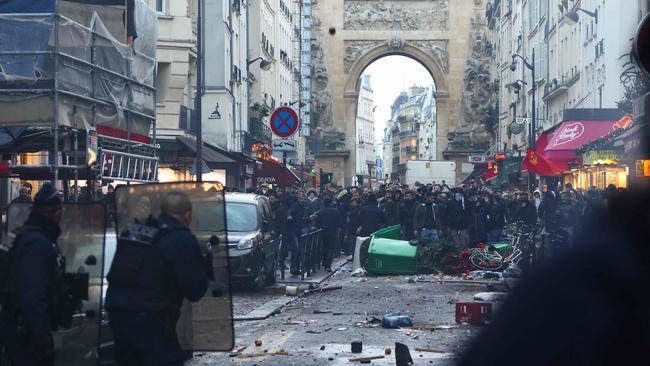 Protesters clashes with French riot police officers following a statement by French Interior Minister Gerald Darmanin at the site where several shots were fired along rue d'Enghien in the 10th arrondissement, in Paris on December 23, 2022. Picture: Thomas Samson / AFP.