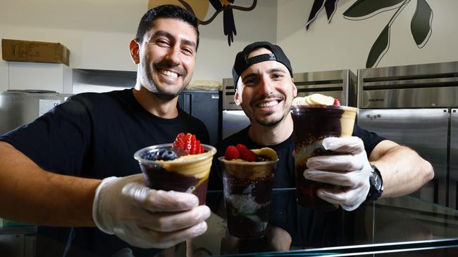 Oakberry Acai is a new health food eatery at the corner of Cairns Esplanade and Shields Street Mall, exclusively offering acai bowls and smoothies. Eduardo Cavalcante and store manager Matheus Ramos prepare a variety of acai bowls, which have proved popular with health concious locals and tourists. Picture: Brendan Radke