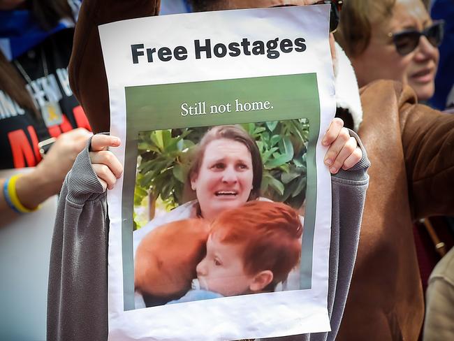 Jewish Australians hold pictures of hostages not yet returned. Picture: Ian Currie