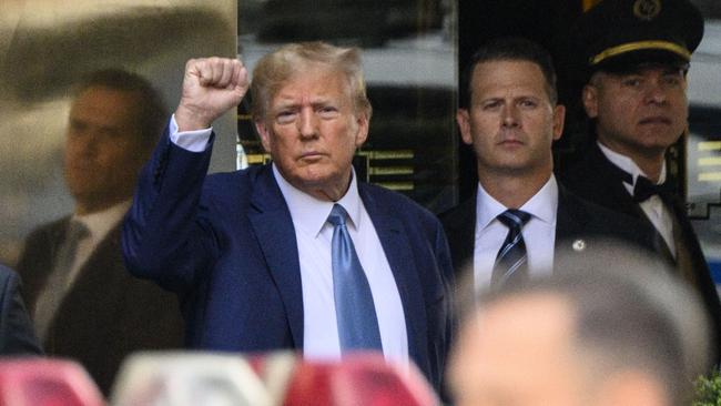 (Former US president Donald Trump pumps his fist as he departs Trump Tower in New York. Picture: AFP