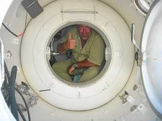 THE POT: Rainbow Beach diver Kevin Phillips in "the pot," one of Queensland's few decompression chambers, where divers with the bends sometimes have to spend 48 hours or so. It is a place most divers hope to avoid. Picture: Contributed